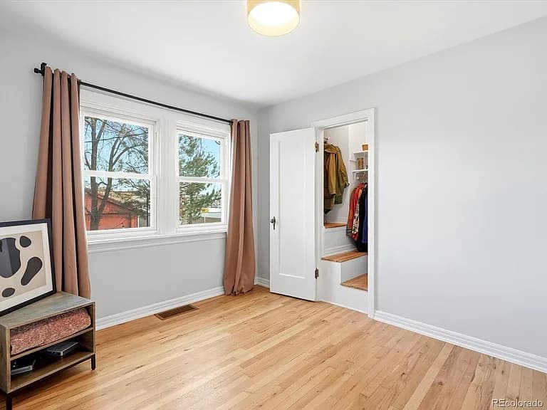Second bedroom with walk-in closet and hardwood floors