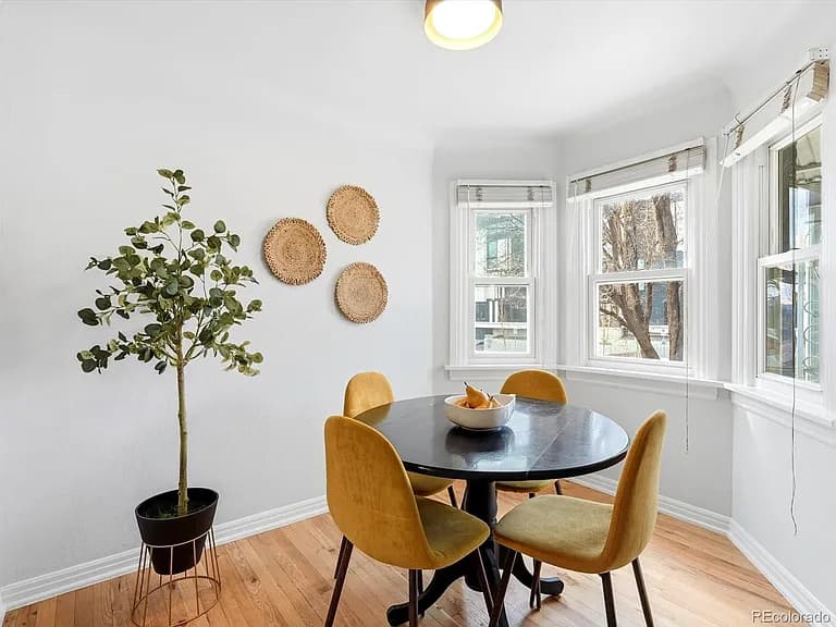 Dining area with bay window and hardwood floors