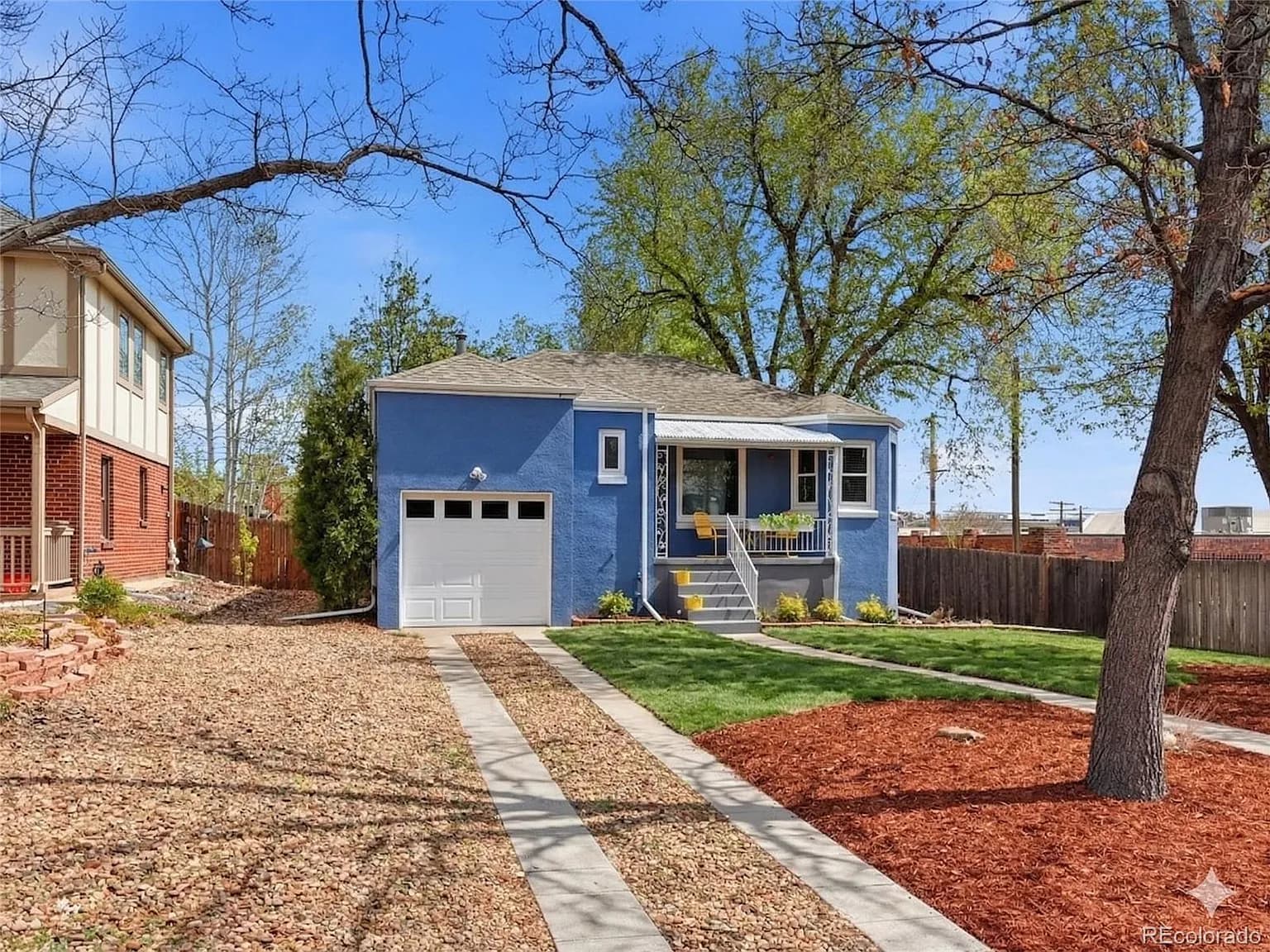 Front exterior of 2924 Zenobia Street — charming blue bungalow with attached garage