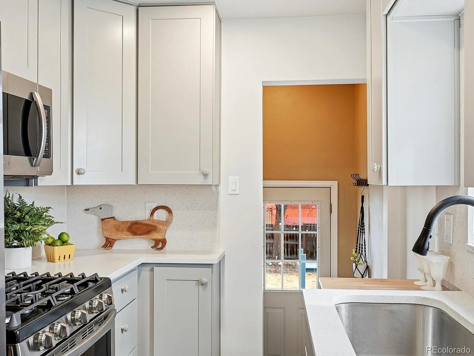 Kitchen detail with white cabinets and quartz countertops