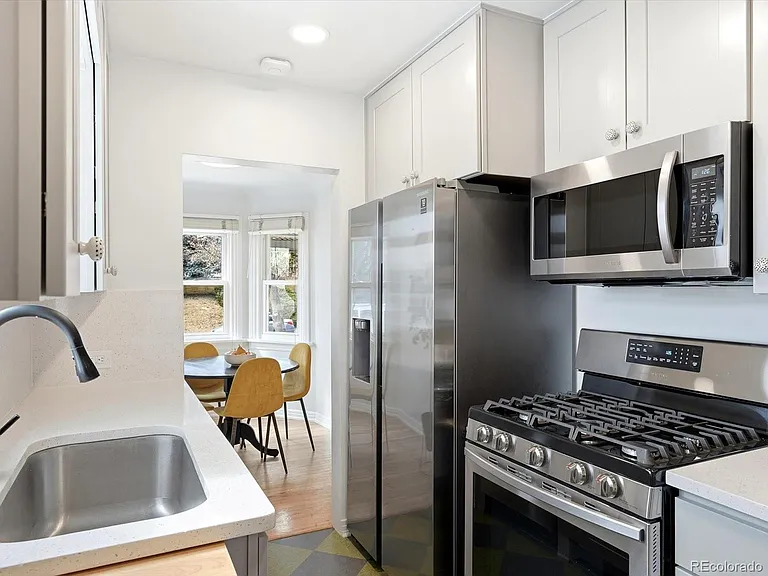 Updated kitchen with stainless steel appliances, gas stove, and quartz counters