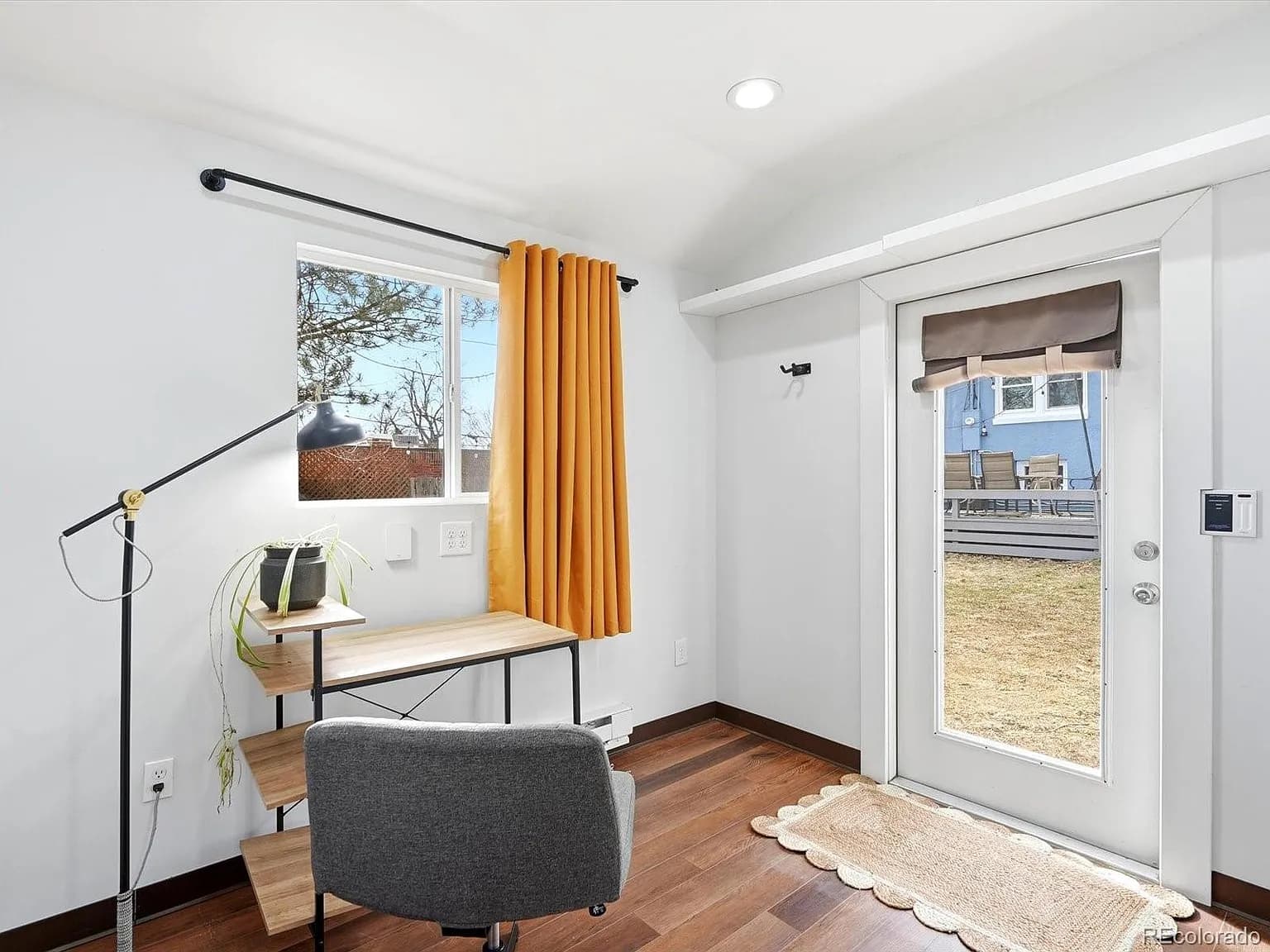Detached studio with desk, glass door, and separate entrance
